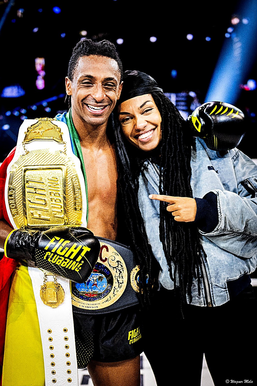 Kebrom Neguse wearing the World Champion and Intercontinental championship belts