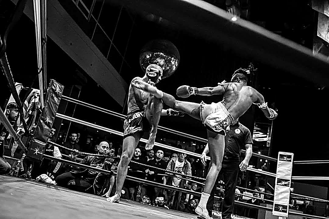 Kebrom Neguse throwing a roundhouse kick during a match